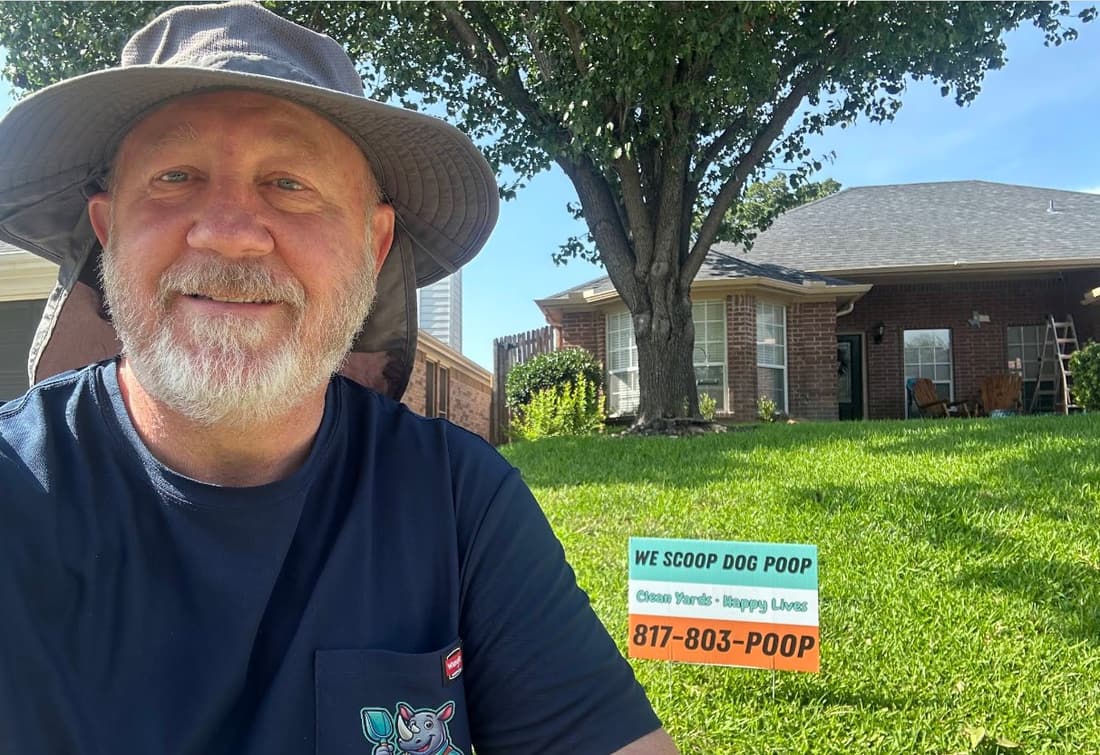Paul scooping a backyard with a rake and pan in Saginaw, Texas